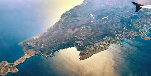 High angle view of sea by mountain against sky