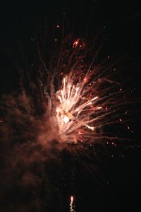 Low angle view of firework display at night