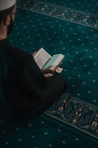 High angle view of man reading book