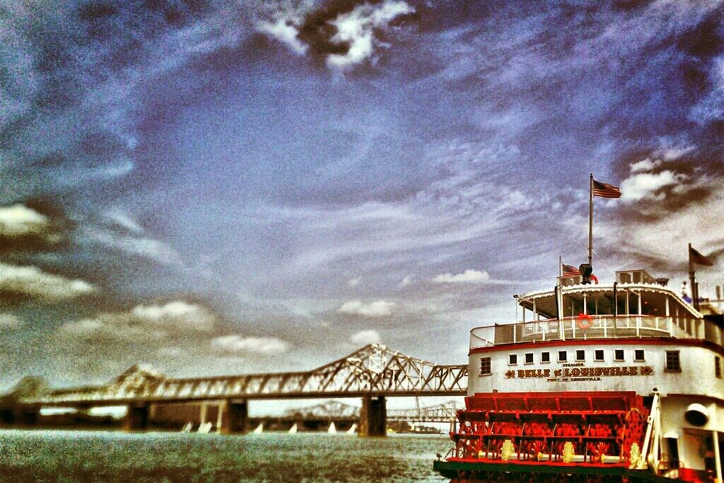 architecture, built structure, building exterior, sky, cloud - sky, cloudy, weather, water, river, overcast, cloud, railing, day, transportation, outdoors, bridge - man made structure, no people, waterfront, nature, connection