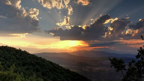 Scenic view of silhouette mountains against sky at sunset