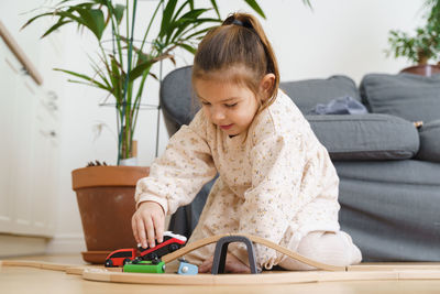 Cute girl playing with toy train