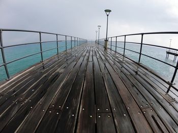 Railway bridge over sea against sky