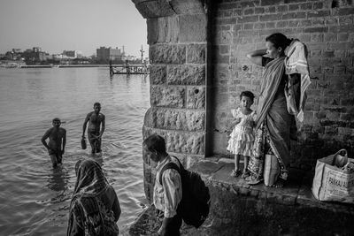 People standing on bridge in city