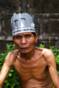 Portrait of shirtless man with text