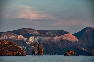 Panoramic view of sea and mountains against sky during sunset