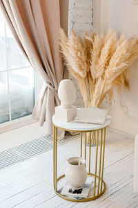 Flower vase on table at home