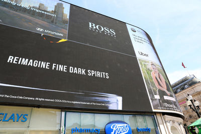 Low angle view of information sign against building