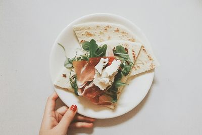 Close-up of hand holding ice cream in bowl