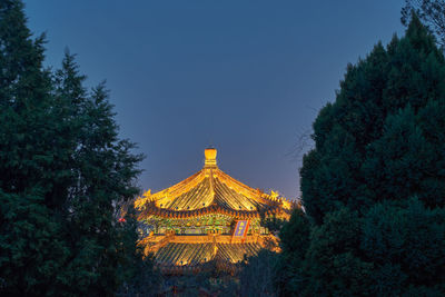 Low angle view of illuminated building against sky