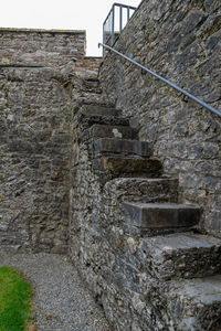 Low angle view of steps against wall