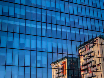 Low angle view of modern glass building in city