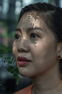 Close-up of woman looking away outdoors