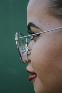 Close-up woman against wall