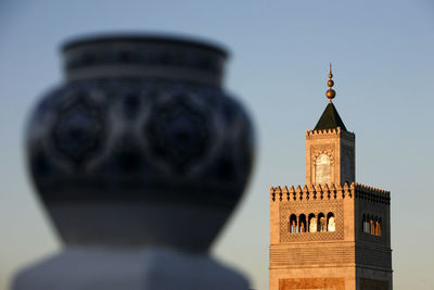 Low angle view of clock tower against sky in city