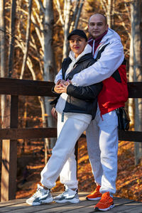 A couple poses in the autumn forest in the mountains.