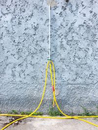 High angle view of yellow water hanging on wall