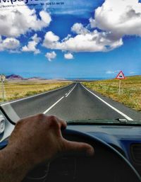 Close-up of hand on car windshield