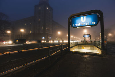 Illuminated sign on street at night