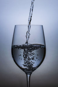 Close-up of wine glass against white background