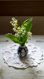 Lily of the valley flowers in vase on table