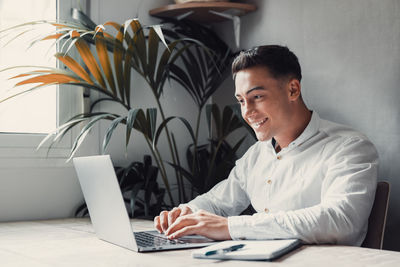 Young woman using laptop at office