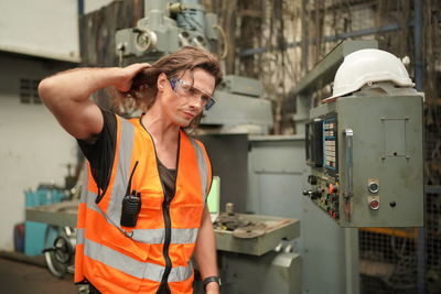 Portrait of male worker standing in the heavy industry manufacturing factory.