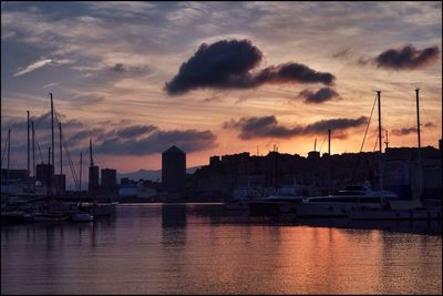 Boats at harbor during sunset