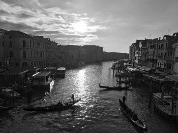 Boats in canal along city