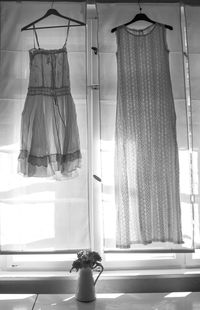 Close-up of clothes hanging on window at home