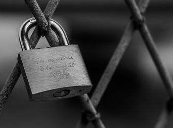 Close-up of padlocks on metal grate