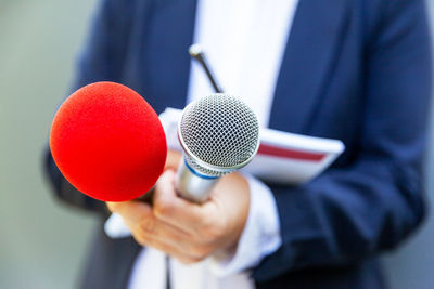 Close-up of woman holding microphone