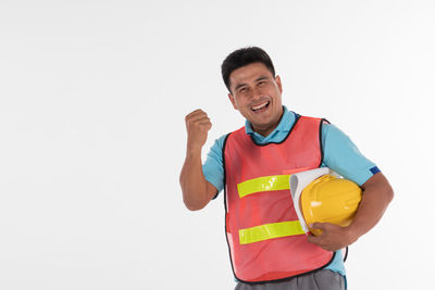 Portrait of smiling man standing against white background