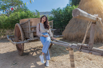 Full length portrait of woman standing outdoors