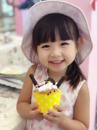 Portrait of smiling girl holding ice cream