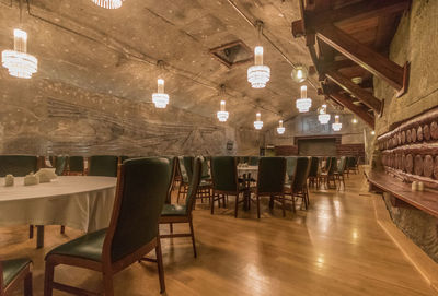 Empty chairs and tables in illuminated restaurant