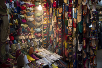 Multi colored shoes for sale at market stall