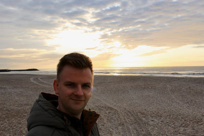 Portrait of man on beach during sunset