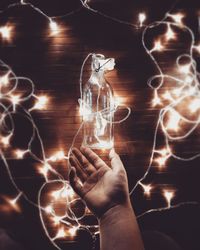 Close-up of hand holding illuminated lights