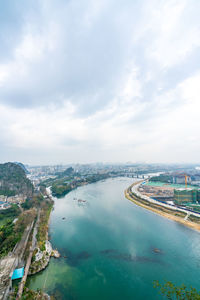 High angle view of sea and city against sky