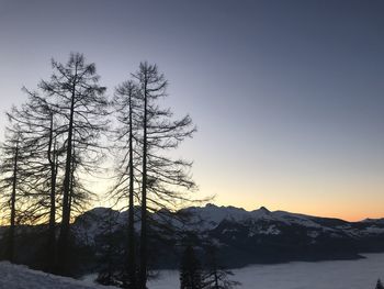 Scenic view of snowcapped mountains against sky at sunset