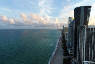 Panoramic view of sea and buildings against sky