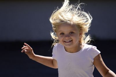 Portrait of smiling girl running outdoors