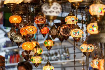 Close-up of illuminated lanterns hanging in store