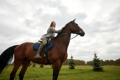 Horse standing on field against sky