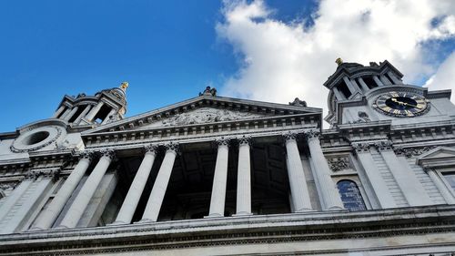 Low angle view of building against cloudy sky