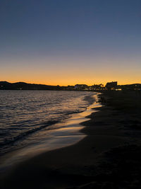 Scenic view of sea against clear sky during sunset