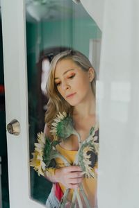 Young woman holding sunflowers