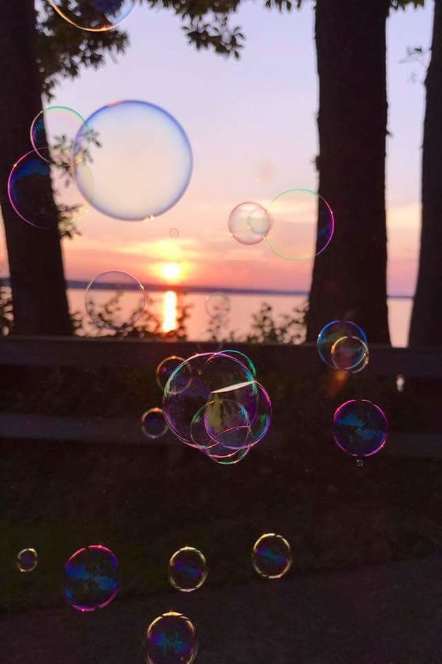 bubble wand, bubble, soap sud, transparent, blowing, fragility, mid-air, rainbow, lightweight, spectrum, fun, refraction, double rainbow, happiness, front view, outdoors, cheerful, honolulu, multi colored, nature, day, flying, one person, tree, people