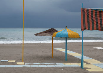 Lifeguard hut on beach against sky